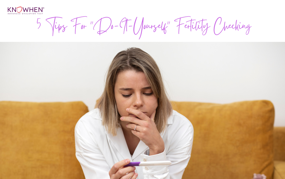 Woman tracking ovulation at home using a fertility chart and saliva test kit.